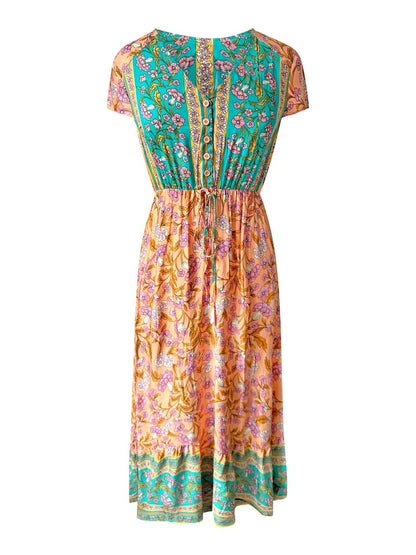 Midi-jurk met bloemenprint in turkooisgroen en perzik.